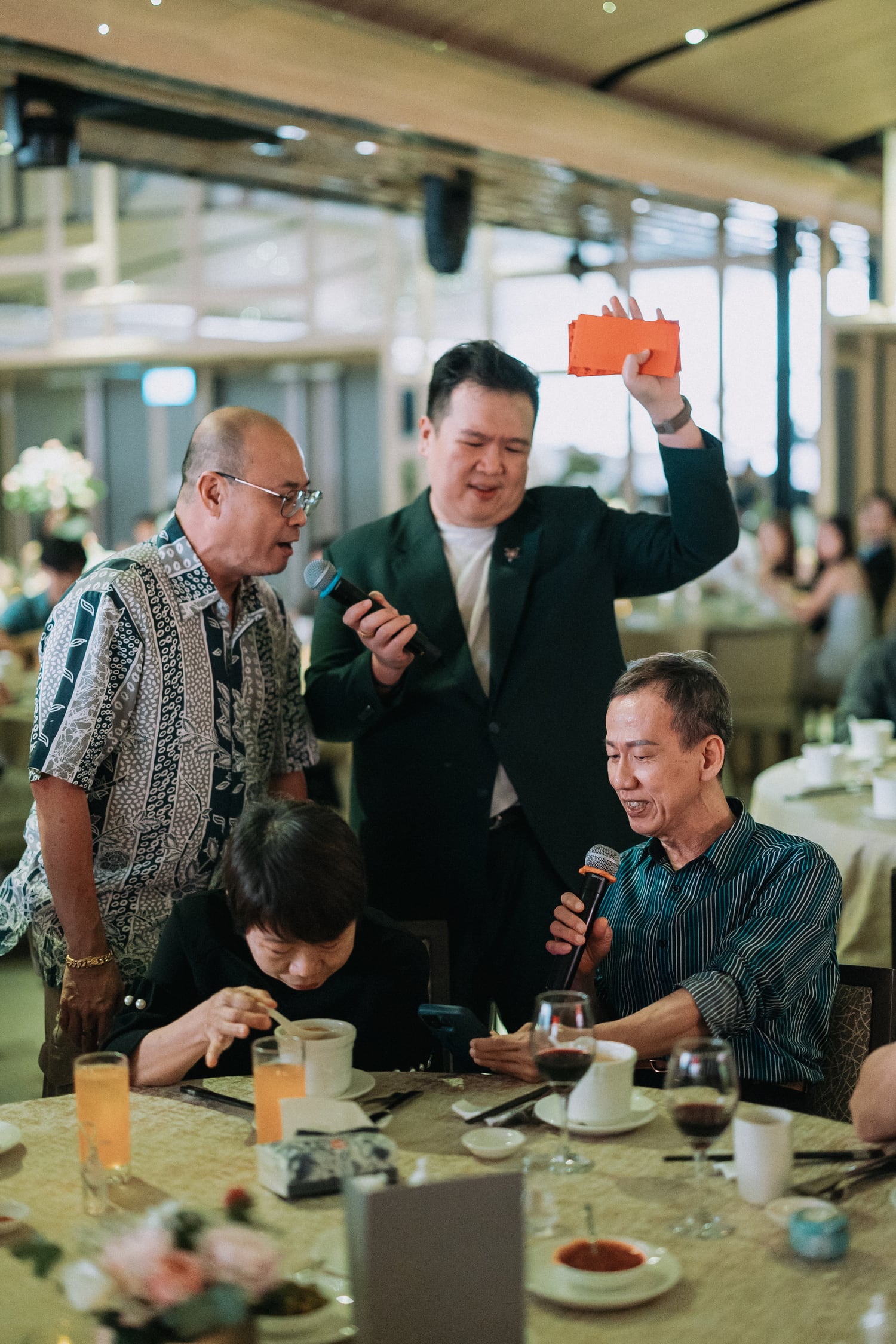 Emcee Dixon engaging elders at a Chinese wedding table in Singapore