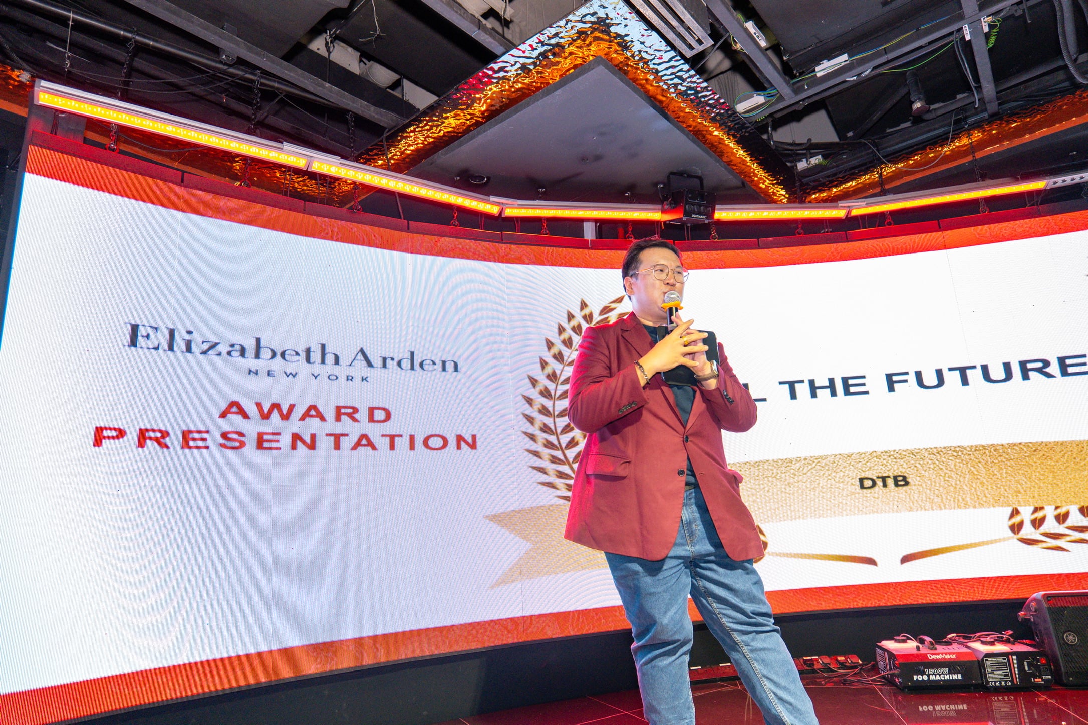 Emcee Dixon hosting a corporate award night on stage in Singapore