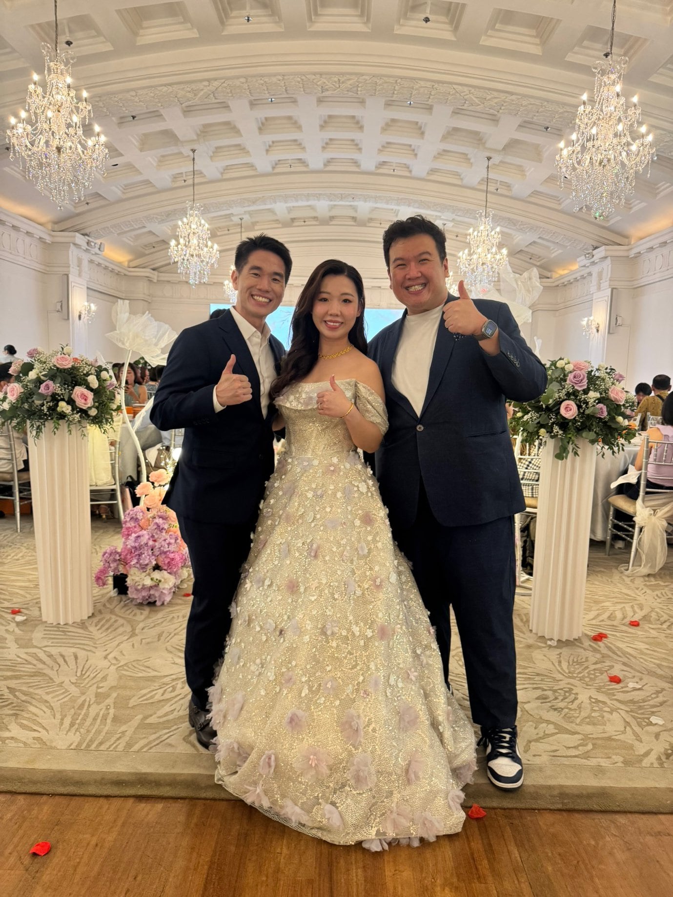 Emcee Dixon with a couple at their ballroom wedding in Singapore