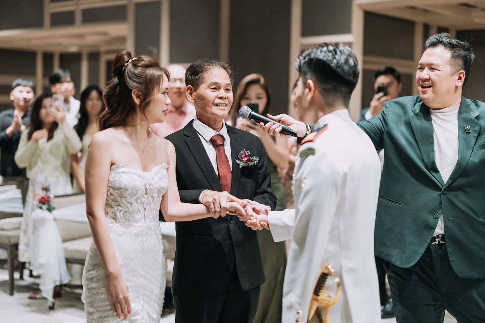 Emcee Dixon with a couple at their solemnisation in Singapore