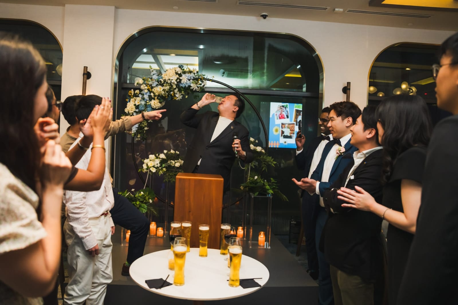 Emcee Dixon leading a lively toast with a couple and their families at a Singapore wedding